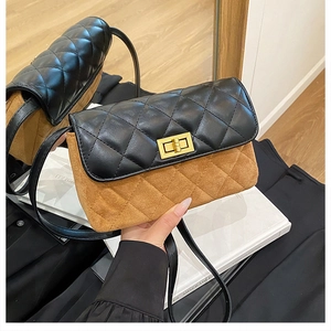 Detail of two-tone quilted crossbody bag with gold-tone twist lock and suede texture