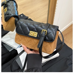 Detail of the quilted texture and golden turn-lock on this vintage leather crossbody bag