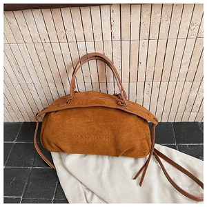 Detail of caramel suede Boston bag showing embossed PANTOOR logo and dual zipper design