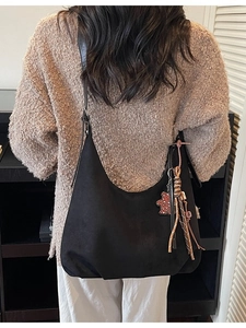 Grand sac hobo en daim noir avec pompon tressé et breloque ours pour le trajet quotidien