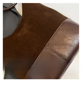 Close-up of brown suede and smooth leather stitching detail on large tote bag