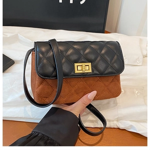 Detail of quilted two-tone crossbody bag featuring brown suede and black leather flap