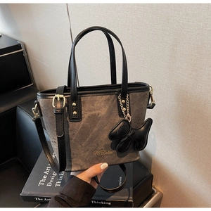Canvas and leather handbag with M'Delun logo, golden hardware and a cute puppy charm