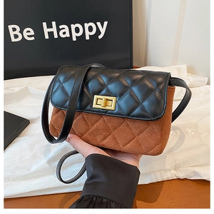 Detail of vintage square bag with black leather flap, brown suede body and gold lock
