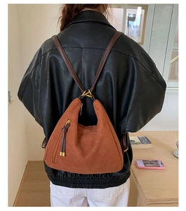 Brown frosted leather hobo backpack with tassel detail shown from a back perspective