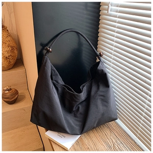 Grand sac fourre-tout en toile noire avec des perles en bois sur la poignée ronde
