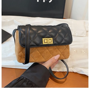 Detail of quilted flap bag with gold turn-lock closure and contrast leather texture