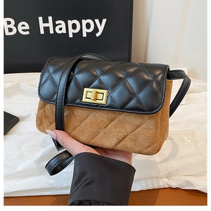 Detailed view of square crossbody bag featuring brown suede and black quilted leather flap