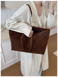 Detail of a dark brown suede tote bag featuring high-capacity design for daily commute