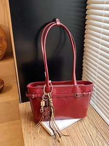 Elegant red patent leather tote bag with vintage design and decorative leopard charms