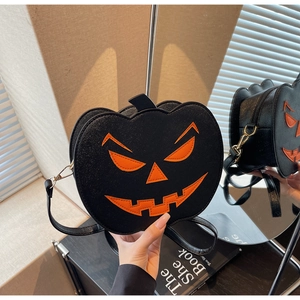Detail view showing the 3D depth and glitter texture of the black pumpkin shoulder bag