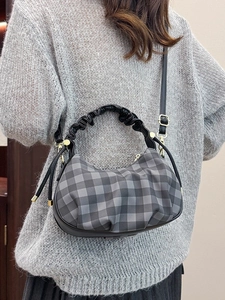 Puffy checkered crossbody dumpling bag with black pleated strap and golden hardware