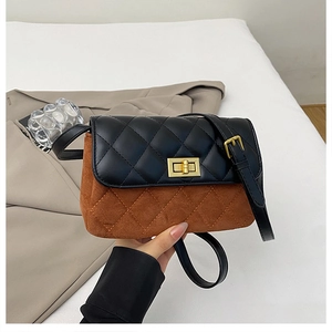 Detail of diamond quilted crossbody bag with golden square lock and leather strap