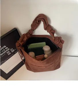 Macro view of spacious brown scrunchie bag interior showing ample storage for daily essentials