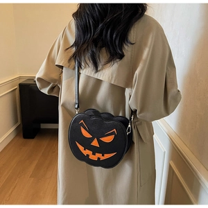 Detail of the pumpkin shoulder bag with orange face and silver metallic lobster clasp