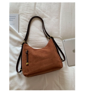 Flat lay of brown frosted suede tote bag with stylish zipper details and shoulder straps