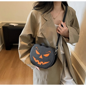 Lifestyle shot of Halloween pumpkin crossbody bag worn with an autumn trench coat