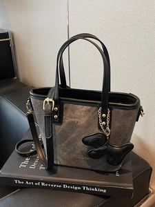 Minimalist dark gray canvas bucket tote bag with leather trim and a cute puppy charm