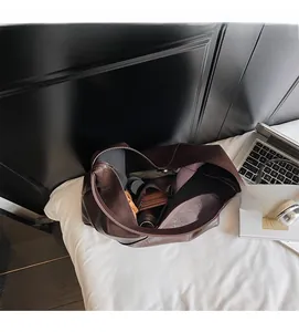 Overhead view showing spacious storage capacity of large brown tote bag with essentials