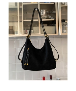 Detail of vintage matte black hobo bag showing suede texture and tassel zipper accent