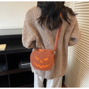 Rear view of a model wearing the orange pumpkin crossbody bag in a warm indoor home setting