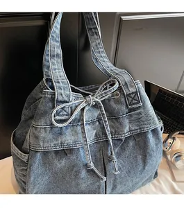 Detail of blue denim tote bag showing drawstring closure and durable fabric texture