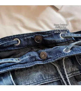Detail of magnetic snap closure and denim drawstring on a casual tote bag