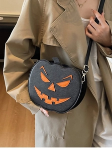 Quirky black pumpkin-shaped crossbody bag for Halloween featuring a jack-o'-lantern face