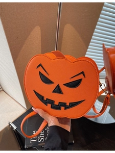 Quirky orange pumpkin shoulder bag with black embroidered face for Halloween outfits