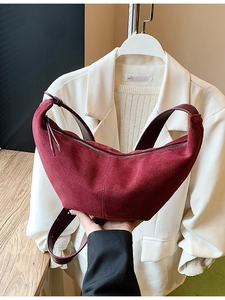 Burgundy matte crescent bag with adjustable leather strap in a minimalist style