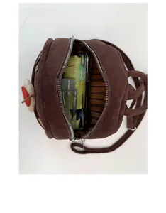 Internal view showing storage capacity for umbrella and phone in brown matte backpack