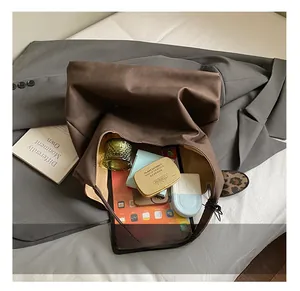 Top view of large dark brown tote bag showing spacious interior with tablet and cosmetics