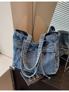 Vintage blue washed denim tote bag with drawstring side detail and dual handles