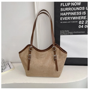 Detail of khaki suede tote bag with brown leather straps and silver buckle accents