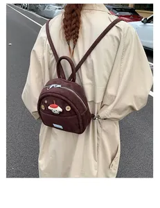 Outdoor shot showing a dark brown corduroy mini backpack worn by a model on the street