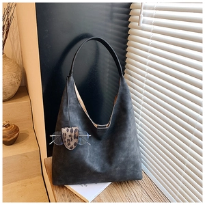 Detail view of dark grey matte tote bag with leopard print eyewear holder ornament