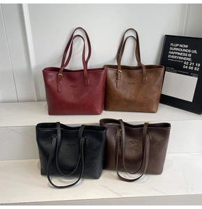 Detail of four large vintage PU leather tote bags in red, brown, black and coffee