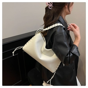 Détail du sac à bandoulière en cuir blanc avec poignée en corde tressée et laçage