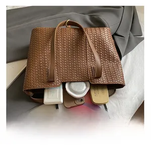 Macro shot of brown woven tote bag interior showing ample storage for daily essentials