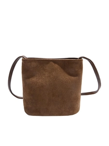 Minimalist brown suede bucket bag for women featuring a slim leather shoulder strap
