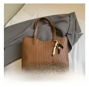 Macro view of woven tote bag texture with beaded tassel and protective metal studs
