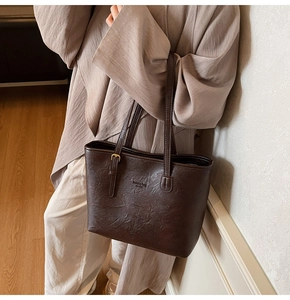 Detail view of vintage brown leather tote bag with fashion bag NEW YORK logo and texture