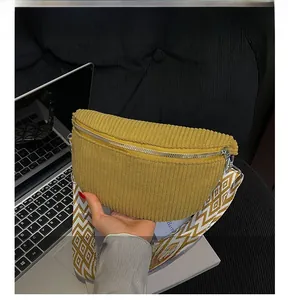 Detail of ginger corduroy moon bag with wide geometric pattern strap and silver zipper
