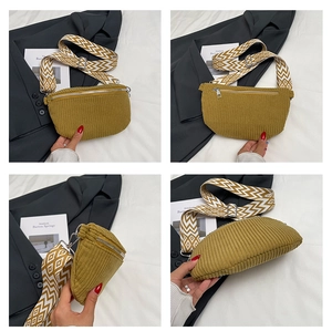 Detail of mustard yellow corduroy waist bag with geometric patterned woven strap