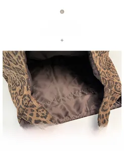 Detail view of the leopard print tote bag interior with brown lining and inner pocket