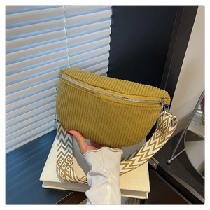 Detail of ginger corduroy bag with wide geometric pattern jacquard strap on book