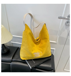 Detail of yellow leopard tote with cartoon bear embroidery and soft suede texture
