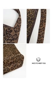 Detail of leopard print tote bag showing stitching quality and smooth brown satin lining