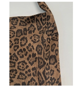 Close-up of leopard print tote bag showing soft suede texture and stitching details