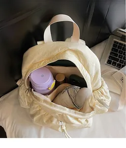 Interior view of off-white canvas backpack showing spacious storage for essentials